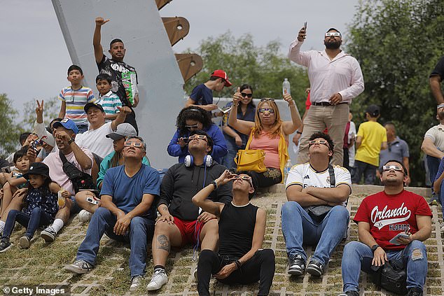 Residents of Torreón, a city in the northeastern Mexican state of Coahuila, gather Monday to watch the total solar eclipse