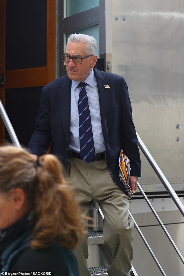 The two-time Academy Award winner was dressed in a navy blazer over a blue plaid button-up shirt and a navy tie with diagonal stripes.