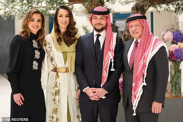 Pictured: Abdullah II (right) and Rania (left) standing with Hussein during his engagement to Rajwa