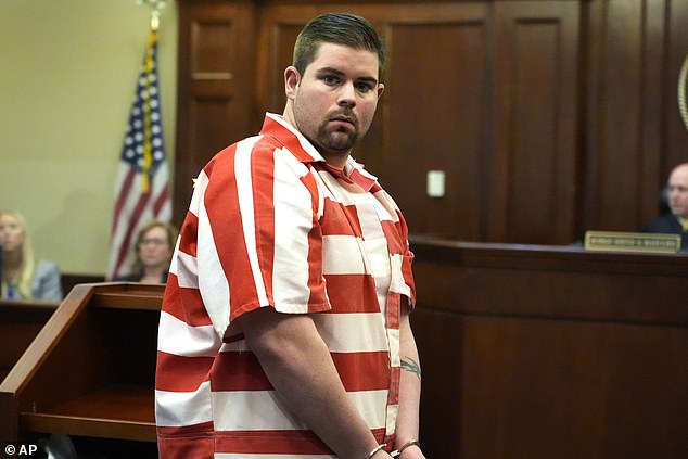 Former Rankin County Sheriff's Deputy Daniel Opdyke looks at his family after his prison sentence was increased from 17.5 to 20 years