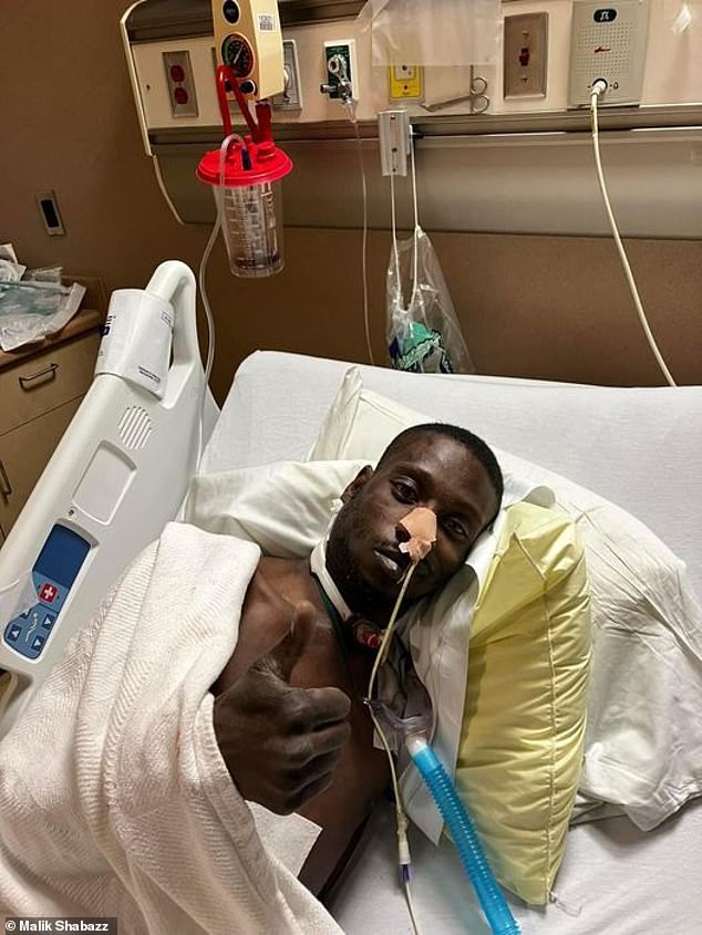 Michael Corey Jenkins in hospital after being shot in the mouth during the attack