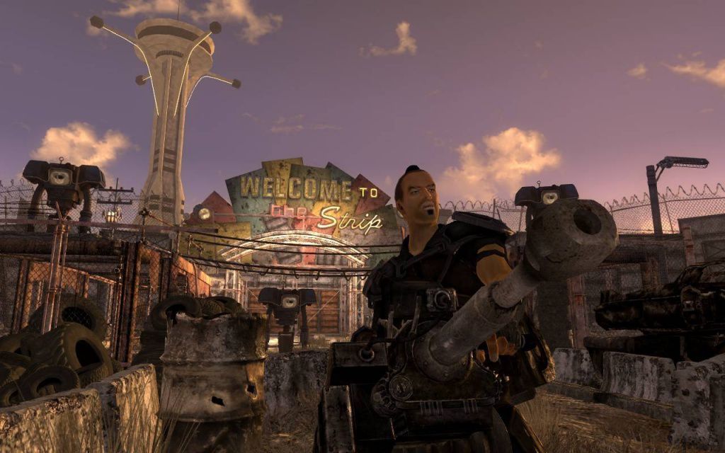 A Fallout: New Vegas screenshot of a man with a gun in front of a sign that reads 'Welcome to the Strip' 