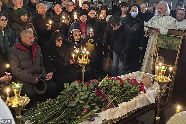 Relatives and friends pay their last respects at the coffin of Russian opposition leader Alexei Navalny in the Church of the Icon of the Mother of God, soothes my grief, March 1