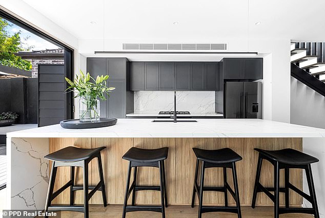 Originally built in the 1930s as a two-bedroom, two-storey semi-detached house, Radley added a further two bedrooms and converted the property into a stylish, luxury property.  In the photo: the beautiful kitchen with breakfast bar