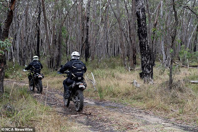 Police on dirt bikes search the woods for the body of Samantha Murphy