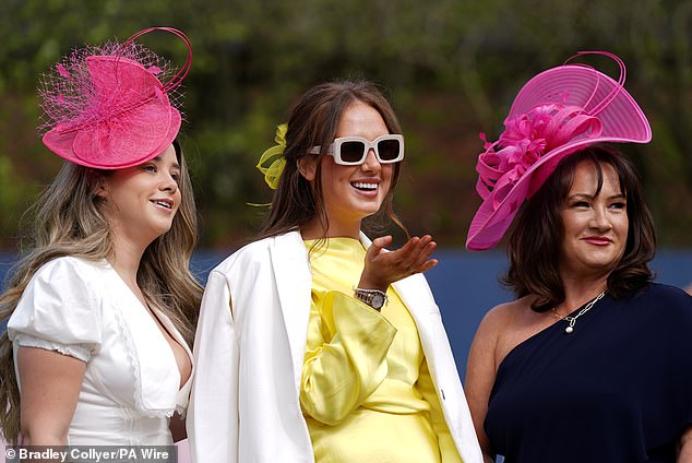 Hat's the ticket!  Two members of this group of glamorous revelers opted for statement pink headpieces to complete their radiant looks