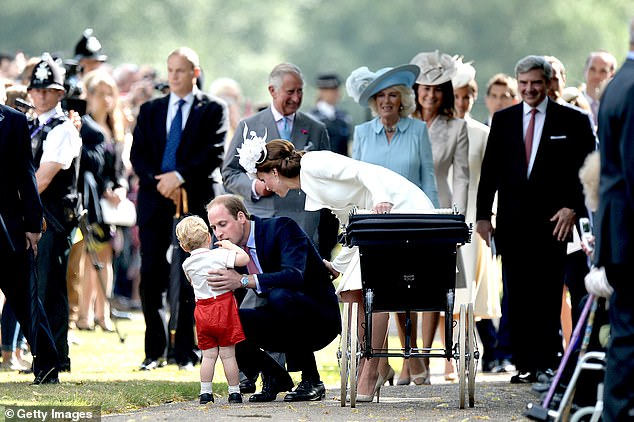 Doting dad William comforts a young George as his in-laws, the Middletons, look on in 2015