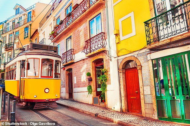 Travelers are 'enchanted' by the Portuguese capital, with its historic districts and emblematic trams (above)