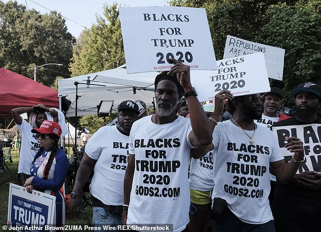 But separate polls spell trouble for Biden in his 2024 re-election bid, with black voters in six of seven swing states favoring Trump over the current president.  Pictured: Blacks for Trump members gather outside the Fulton County Jail in Atlanta, Georgia in August 2023 to support the president as he arrived to turn himself in and have his mug shot taken