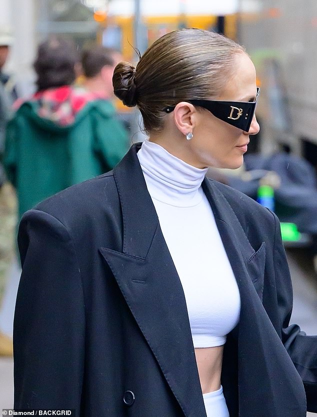 The 54-year-old pop star covered her makeup-free face with a pair of $315 DSQUARED2 'Hype Black' sunglasses and she scraped her natural brunette bob into a severe bun