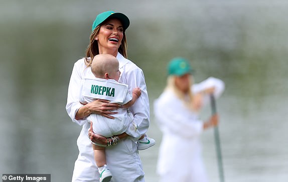 AUGUSTA, GEORGIA - APRIL 10: Brooks Koepka of American woman, Jena Sims, holds their son Crew during the Par Three Contest prior to the 2024 Masters Tournament at Augusta National Golf Club on April 10, 2024 in Augusta, Georgia.  (Photo by Andrew Redington/Getty Images)