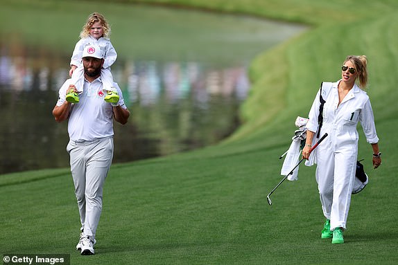 AUGUSTA, GEORGIA - APRIL 10: Jon Rahm of Spain holds his son Kepa and walks with his wife Kelley Cahill during the Par Three Contest prior to the 2024 Masters Tournament at Augusta National Golf Club on April 10, 2024 in Augusta, Georgia.  (Photo by Andrew Redington/Getty Images)