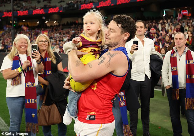 Neale carried his daughter Piper as he celebrated his 250th AFL match