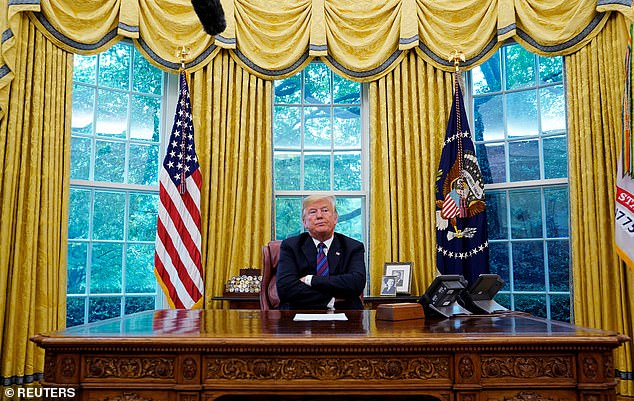 Trump, pictured here in the Oval Office, has indicated he wants to work at the Resolute Desk for more than eight years