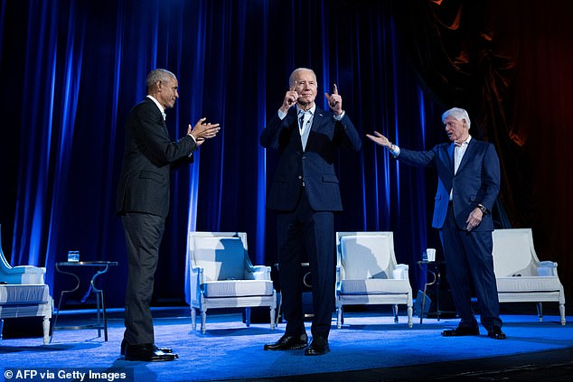 Former President Barack Obama (left) and former President Bill Clinton (right) cheer on President Joe Biden (center) during a campaign fundraising event at Radio City Music Hall