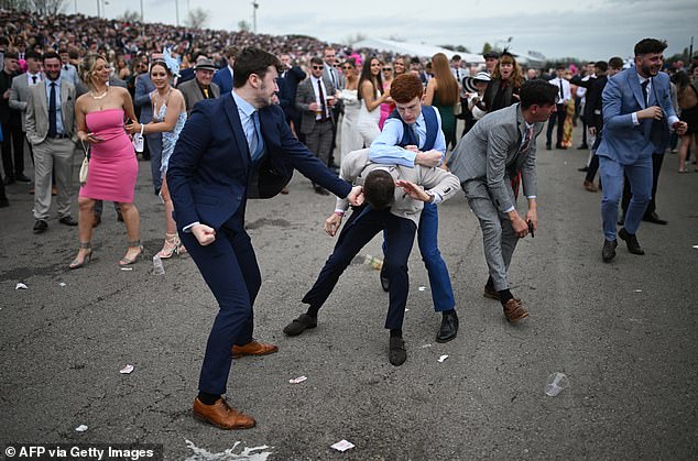 A third shows a number of men huddled in the middle of a huge crowd