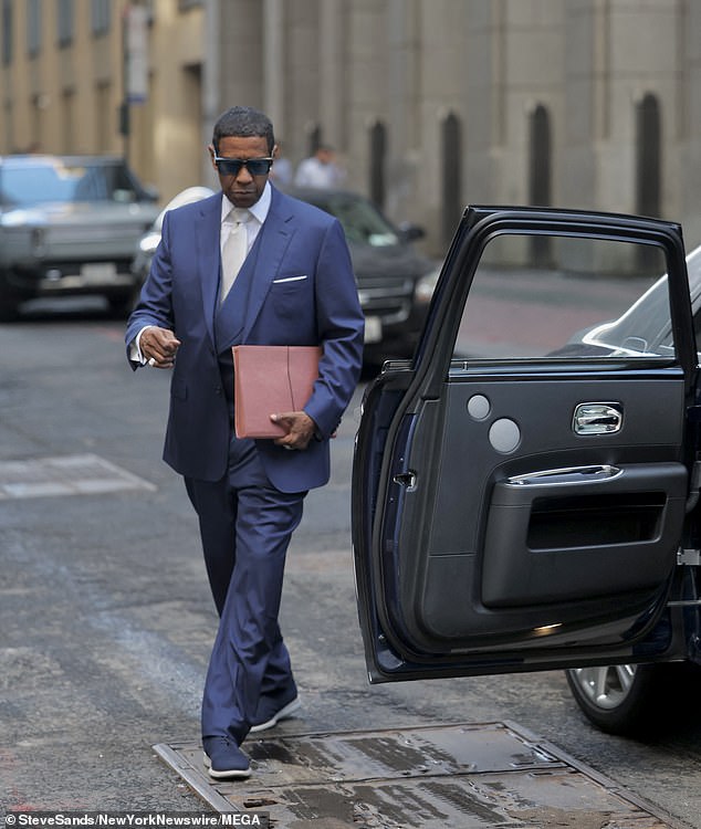 The shoot seemed to revolve around a blue and silver car parked on the side of a street