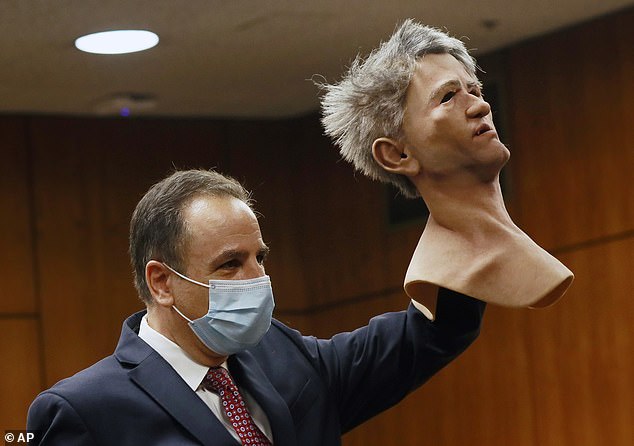 Deputy District Attorney Habib A. Balian holds a rubber latex mask worn by Robert Durst when police arrested him in New Orleans in 2015