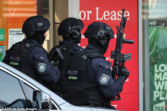 Tactical police are depicted with long-arm weapons