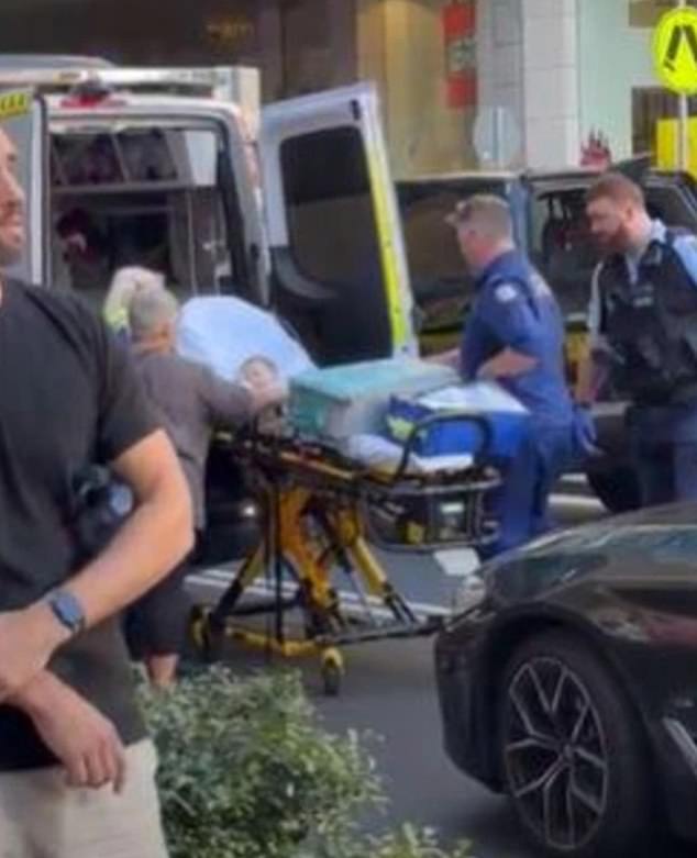The baby who was among the nine stabbing victims is pictured being taken into an ambulance
