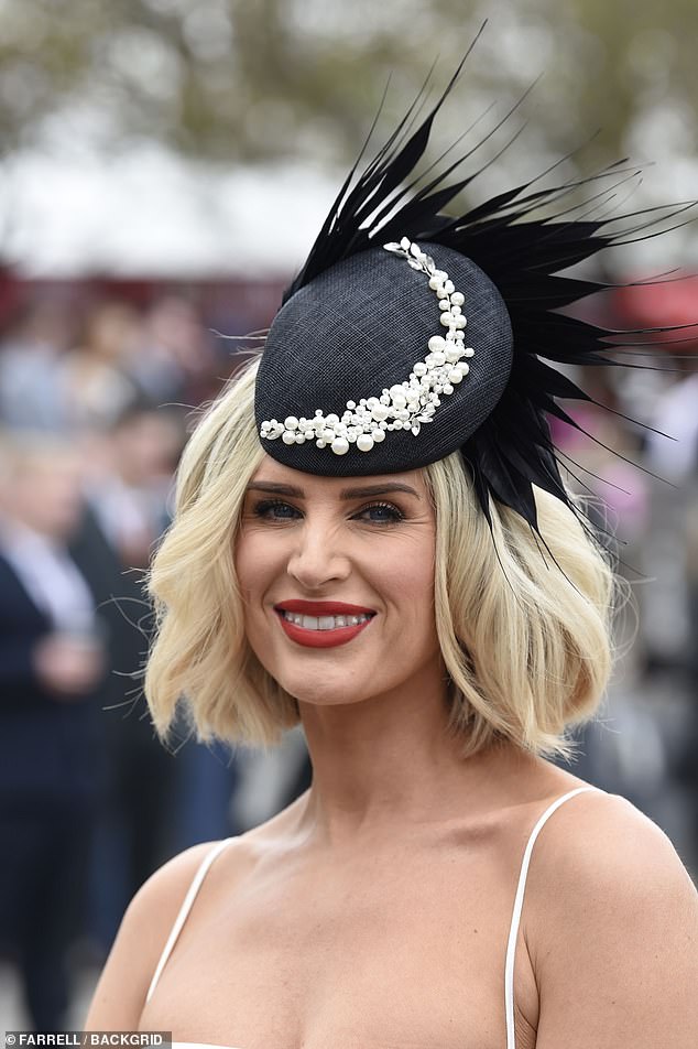 The 42-year-old star added a black fascinator adorned with pearls, while she added a pop of color with a bold red lip