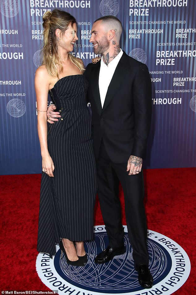 While posing on the red carpet ahead of the event celebrating scientific achievements, the supermodel and Maroon 5 frontman were seen laughing and smiling as they gazed into each other's eyes.