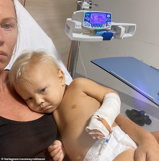 A scan in March found cancer cells in 84 percent of Max's body, while a scan just a month earlier found no cancer cells (pictured, Max and Mrs Robinson in hospital)