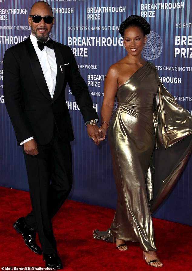 Alicia Keys, resplendent in a shimmering gold number that trended off the shoulder on one side, strolled down the red carpet hand-in-hand with her bespoke husband Swizz Beatz