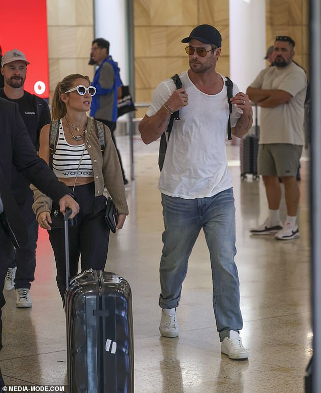 Chris, meanwhile, showed off his muscular physique in a thin white T-shirt and jeans, paired with white sneakers, a black baseball cap and brown-tinted aviator sunglasses.