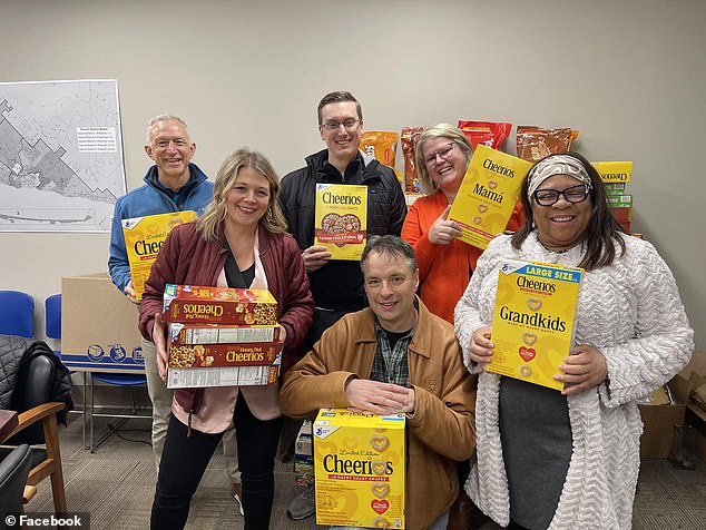 Following her comments, locals donated hundreds of boxes of cereal to a food drive in the city.  Reinert (far left, back) was photographed with a box of Cheerios at the drop-off location