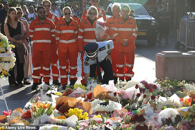 People, including first responders, left flowers in front of the scene of the crime in memory of those who died