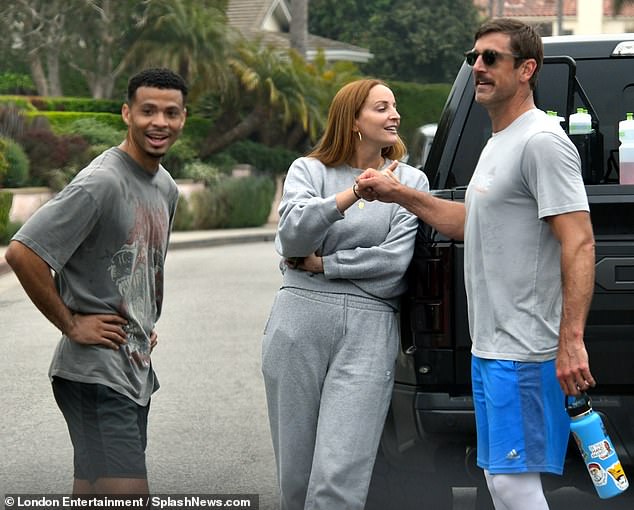 Rodgers is seen throwing some fist bumps after working out with some USC Trojans