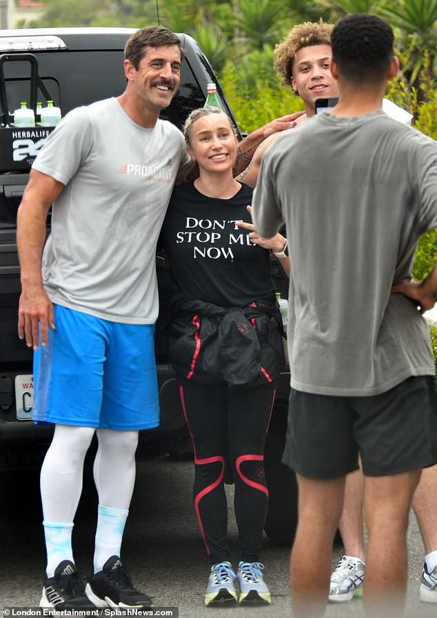 Rodgers takes photos with spectators near the Santa Monica steps after practice