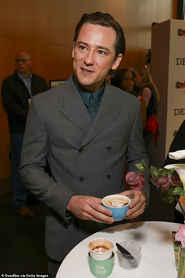 Lewis Pullman looked chic in a gray double-breasted suit, which he paired with a forest green button-up shirt