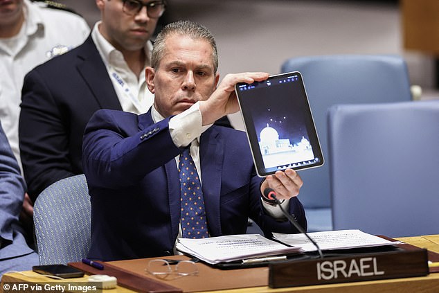 Israeli Ambassador to the UN Gilad Erdan shows a video during a meeting of the United Nations Security Council on the situation in the Middle East