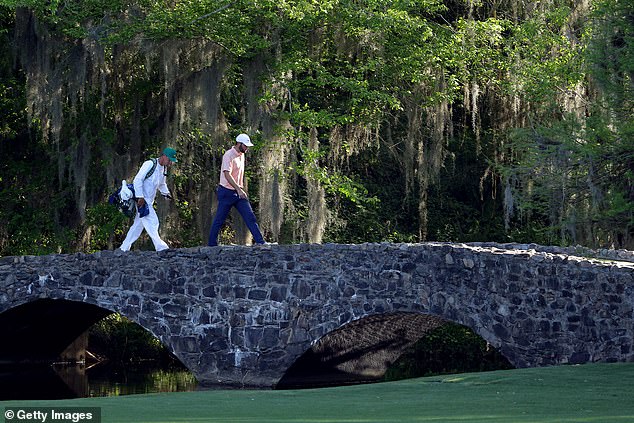 Scheffler walks across the Nelson Bridge on hole 13 during the final round of The Masters