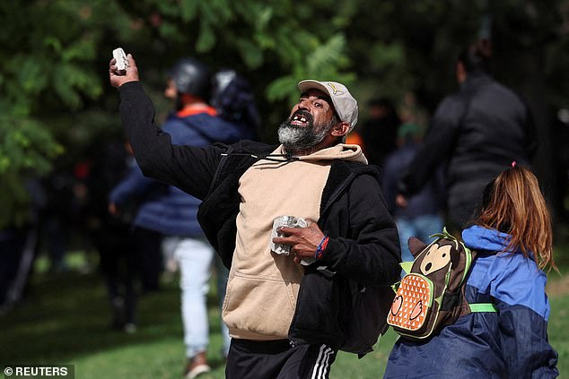 A protester throws a stone at a demonstration over government job losses in Buenos Aires