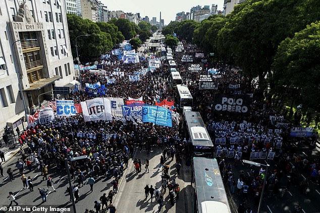 Protesters marched along 9th of July Avenue, the main street in Argentina's capital Buenos Aires, on Wednesday to denounce cuts to public sector jobs and improvements to soup kitchens.