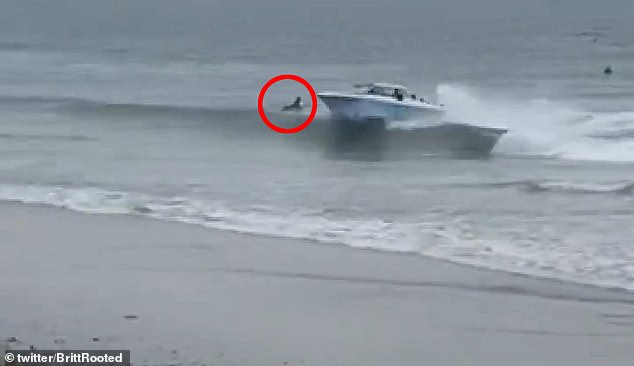 The boat missed what appeared to be a surfer in the water by a few meters as it zoomed past and approached the beach at very high speed