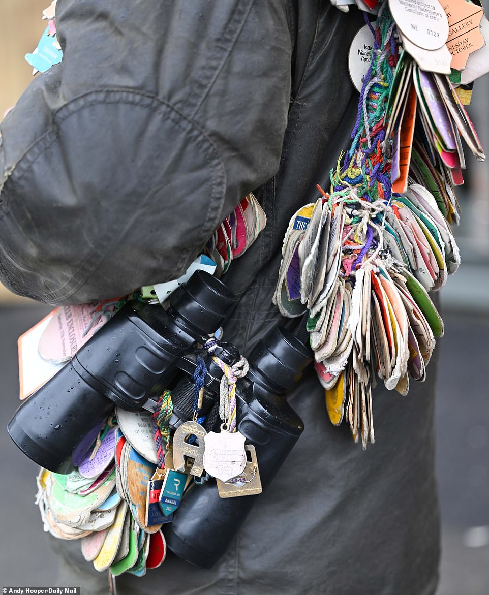 A seasoned racegoer shows off his colorful collection of passes and badges at locations across the country