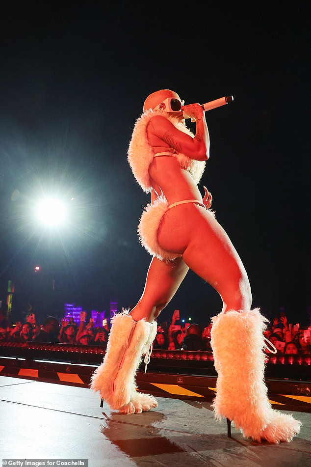 The singer stomped around in white furry high-heeled boots
