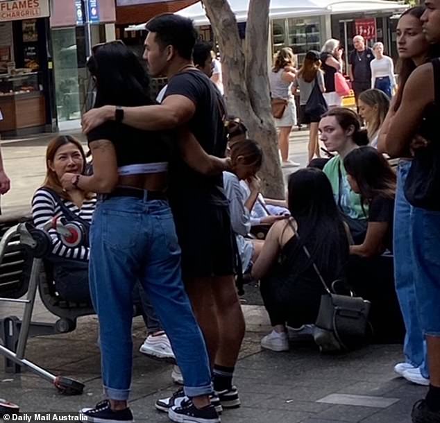 Calvin Klein employees and their loved ones (woman on the left, couple on the left, and woman and man on the right) and Tommy Hilfiger executives and their friends (sitting on the couch/crouching on the floor in the middle) visited the monument to pay tribute to the victims