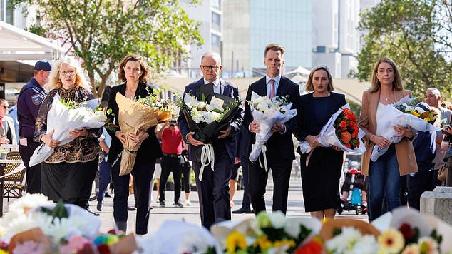 Anthony Albanese (pictured laying flowers in the mall) announced that all government buildings would lower their flags while half-masked as a sign of 'mourning and respect'