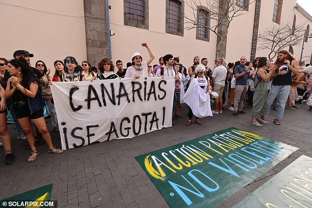 Protesters hold signs reading: 'The Canary Islands are exhausted'