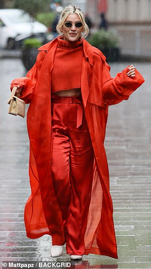 The former Pussycat Dolls singer, 42, paired the striking red knitwear with matching satin wide-leg trousers and a long semi-sheer red trench coat