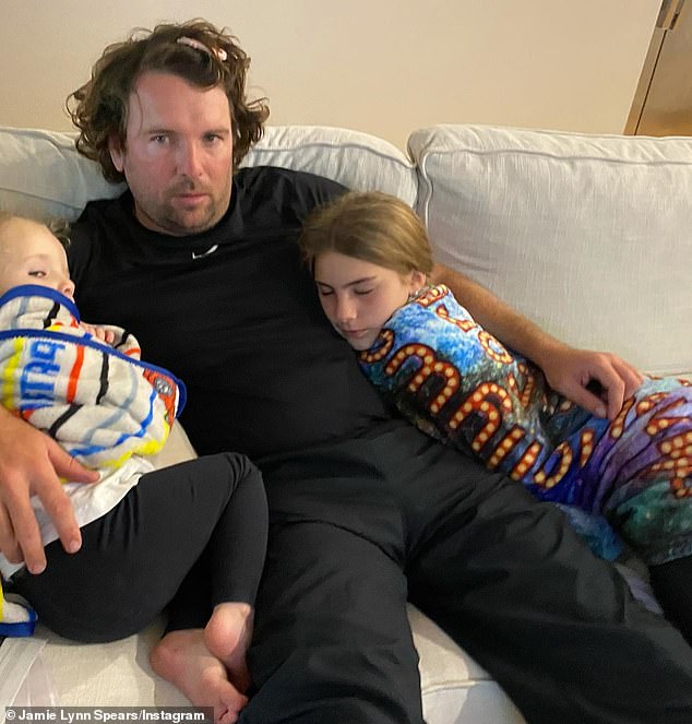 Another adorable photo was shared of their daughters Maddie and Ivey cuddling with their dad