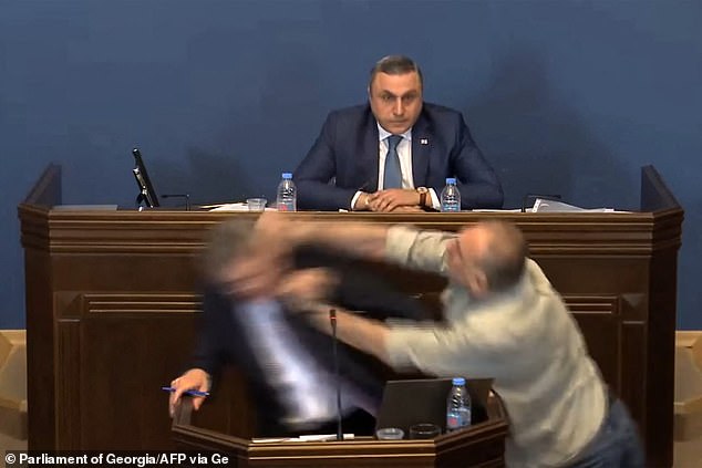 Video of the incident shows the politician – MP Aleko Elisashvili – charging in from the speaker's left, waving his fist and making contact with the man's face.  Another politician sitting behind the speaker looks on, open-mouthed and shocked