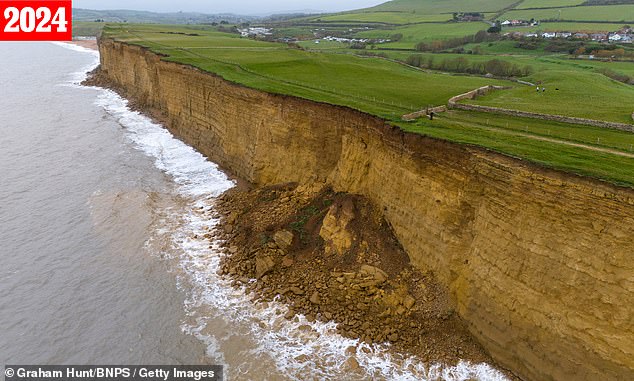 Pictured in 2024: The cliffs at nearby Burton Bradstock are seen increasingly crumbling into the sea over time