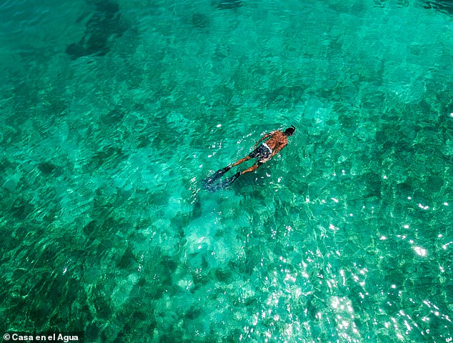 Guests can swim in the clear Caribbean waters surrounding the hostel