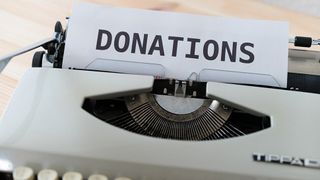 A typewriter and a sheet of paper for donations..